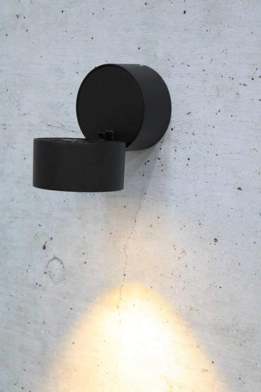 Tiltable black metal wall light