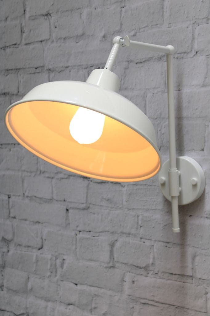 warehouse wall light with white arm and white shade in tilted position