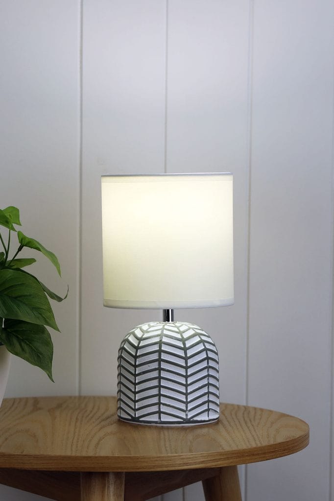 ceramic lamp with white and black finish on a table