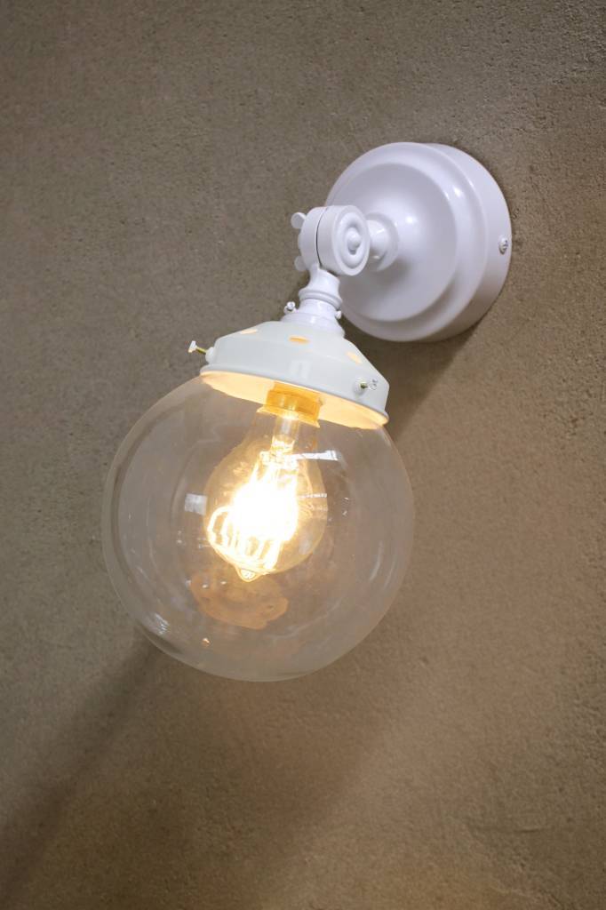 White wall light with white gallery and clear shade against a concrete background